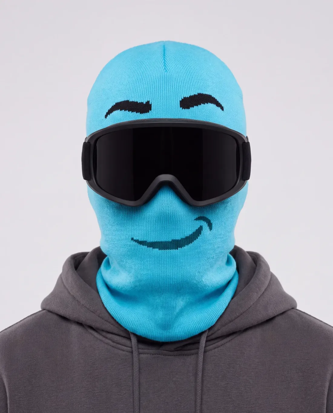 GRIMM cyan character ski mask, front studio view, worn with black-lens ski goggles